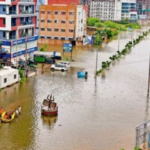 Workers conducting dredging and desilting operations in the Vishwamitri River to increase its flood-carrying capacity.