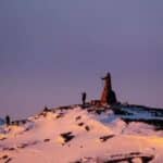 Snow-covered hills in Greenland with US flag in Arctic context