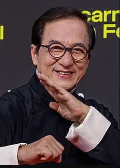 Jackie Chan performing a daring martial arts stunt on set